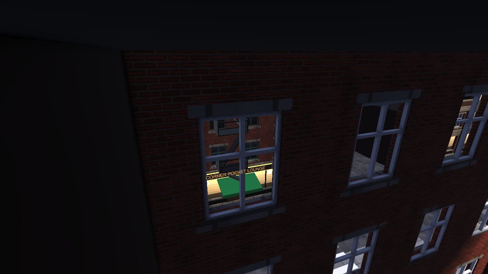 A lit upstairs window at night with two pool tables inside, under a Corner Pocket Lounge sign